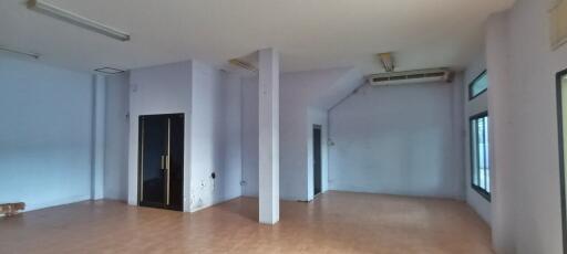 Spacious empty living room with tiled floors and ample natural light