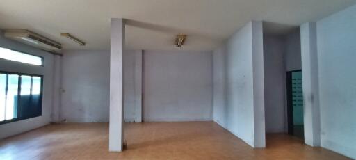 Spacious empty living room with large windows and air conditioning