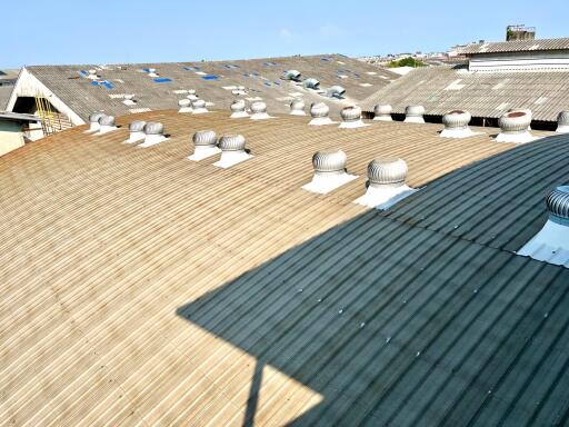 Wide industrial rooftop with multiple ventilation systems