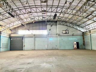 Spacious industrial warehouse interior with basketball hoop