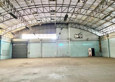 Spacious industrial warehouse interior with basketball hoop