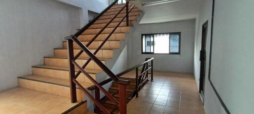 Spacious and modern staircase area with wooden stairs and ample natural light