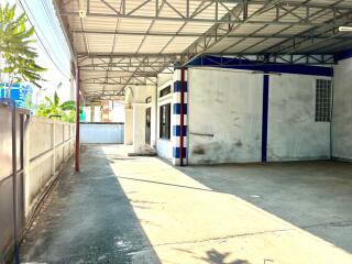 Spacious covered garage area with blue and white accents