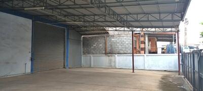 Spacious industrial warehouse with covered area and secure entry