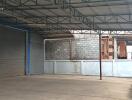 Spacious industrial warehouse with covered area and secure entry