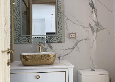 Modern bathroom with decorative patterns and marble walls
