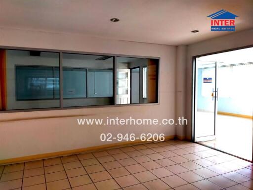 Spacious and brightly lit living room with large windows and access to balcony