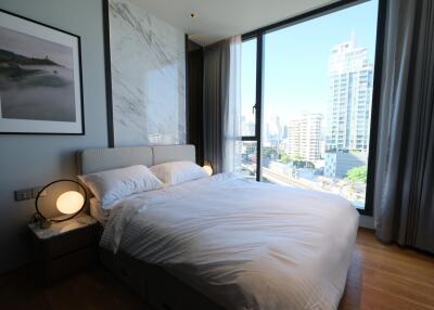 Modern bedroom with city view through large window