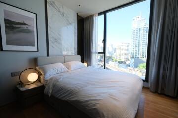 Modern bedroom with city view through large window