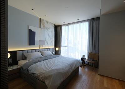 Modern bedroom with large window and contemporary art