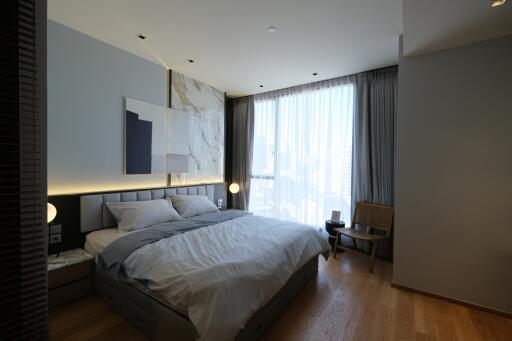 Modern bedroom with large window and contemporary art