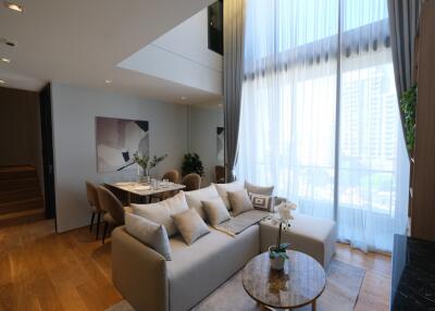 Modern living room with high ceiling and natural light