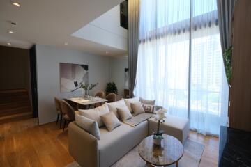 Modern living room with high ceiling and natural light