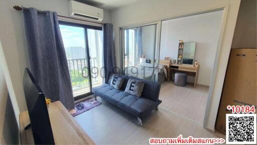 Modern living room with grey sofa and balcony access