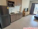 Spacious studio apartment with kitchen, living area, and city views