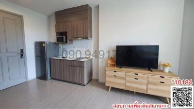 Modern living area with kitchenette and entertainment unit