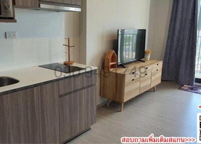 Modern studio apartment interior with kitchenette and living space