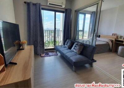 Modern bedroom with a view, featuring a seating area and ample natural light