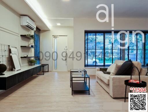 Spacious and modern living room with large windows and stylish furniture