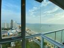 High-rise apartment living room with expansive beachfront and city view