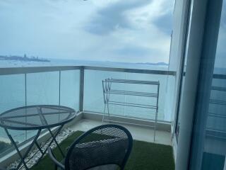 Ocean view balcony with seating area