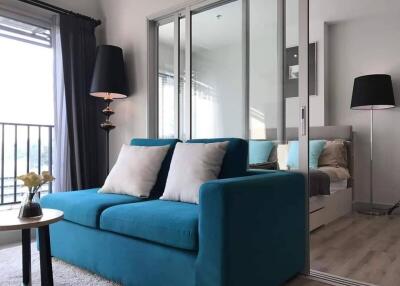 Modern living room with blue sofa and large mirrors