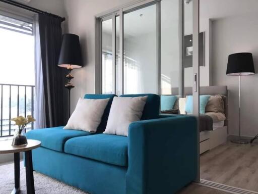Modern living room with blue sofa and large mirrors