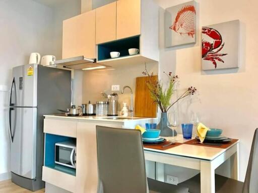 Modern kitchen with efficient space utilization, stylish appliances, and a cozy dining setup