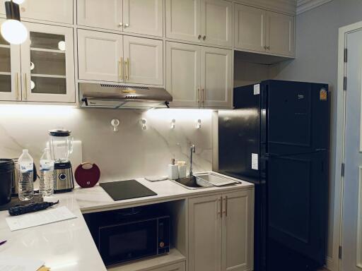 Modern kitchen with white cabinetry and stainless steel appliances