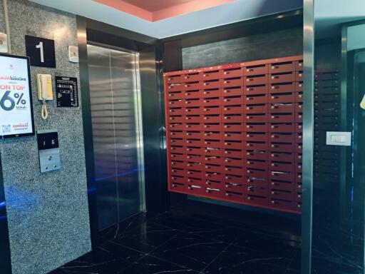 Modern apartment building lobby with mailboxes and elevator