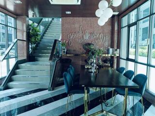 Elegant lobby area with decorative staircase and stylish seating arrangement
