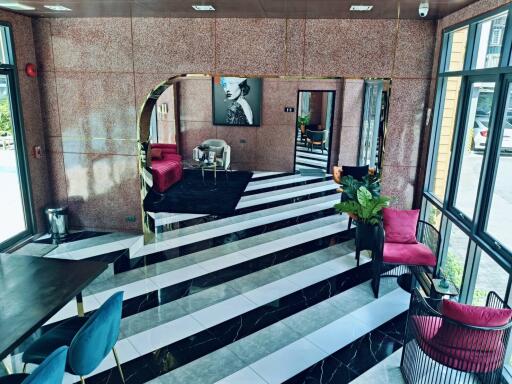 Elegant lobby with monochrome striped flooring and stylish furnishings