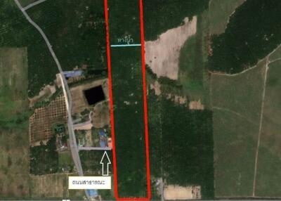 Aerial view of a long rectangular property plot bordered by roads and other plots