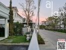 Suburban neighborhood street view at twilight with elegant homes and landscaped yards