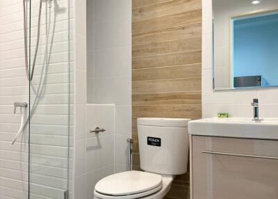 Modern bathroom with wooden accents and white fixtures