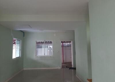 Unfinished bedroom with green walls and bare concrete floor