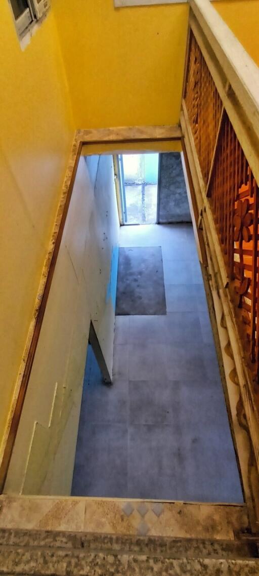 Bright yellow staircase with blue carpeting in a residential building