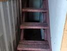 Narrow wooden staircase in a building