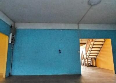 Spacious blue-painted garage with direct staircase access