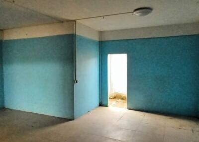 Empty bedroom with blue walls and natural light