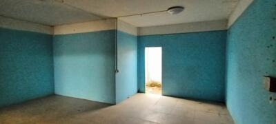 Empty bedroom with blue walls and natural light