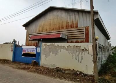 Rustic and weathered warehouse exterior with faded walls and metal roof