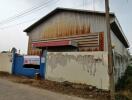 Rustic and weathered warehouse exterior with faded walls and metal roof