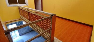 Spacious hallway with vibrant yellow walls and wooden features