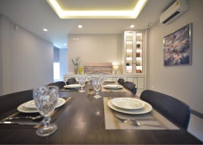 Elegantly set dining table in a modern dining room with ambient lighting