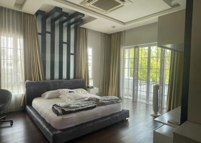 Modern spacious bedroom with large windows and luxurious design