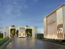 Elegant building entrance with landscaped pathway at dusk