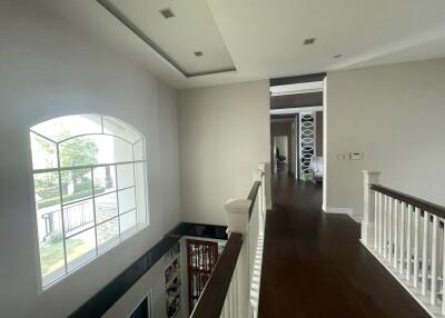 Spacious upper floor hallway with large window and view into the yard
