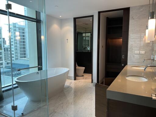 Luxurious modern bathroom with freestanding tub and cityscape view