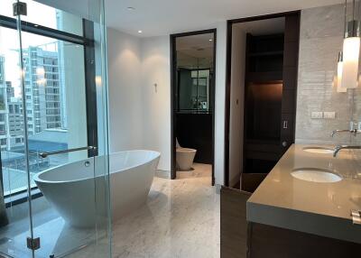Luxurious modern bathroom with freestanding tub and cityscape view